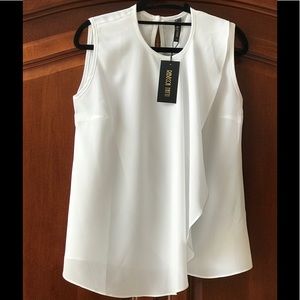 Ruffled White Sleeveless Top by Rebecca Tatti M